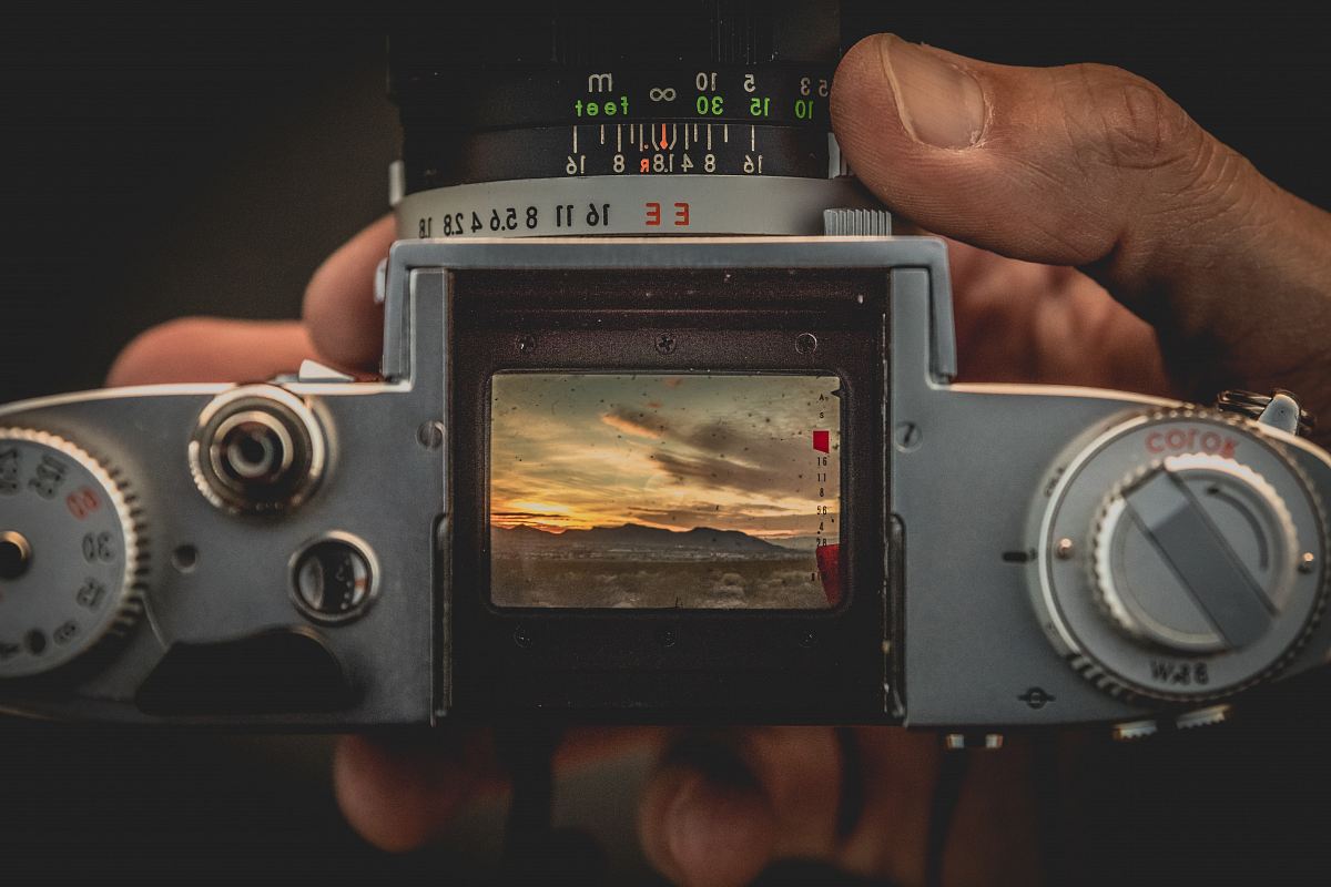 person holding gray film camera
